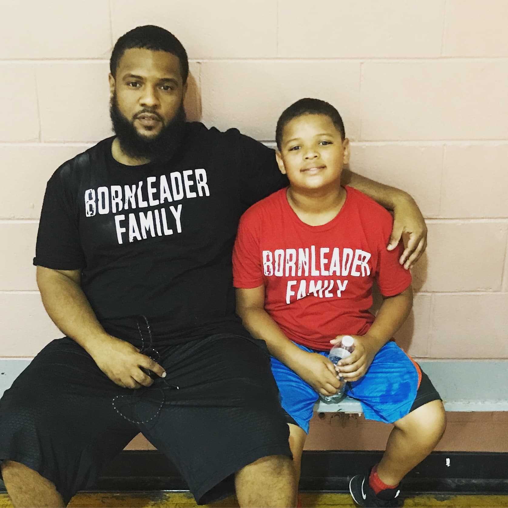 Born Leader Family mentor and youth in matching BLF shirts, bonding at the gym