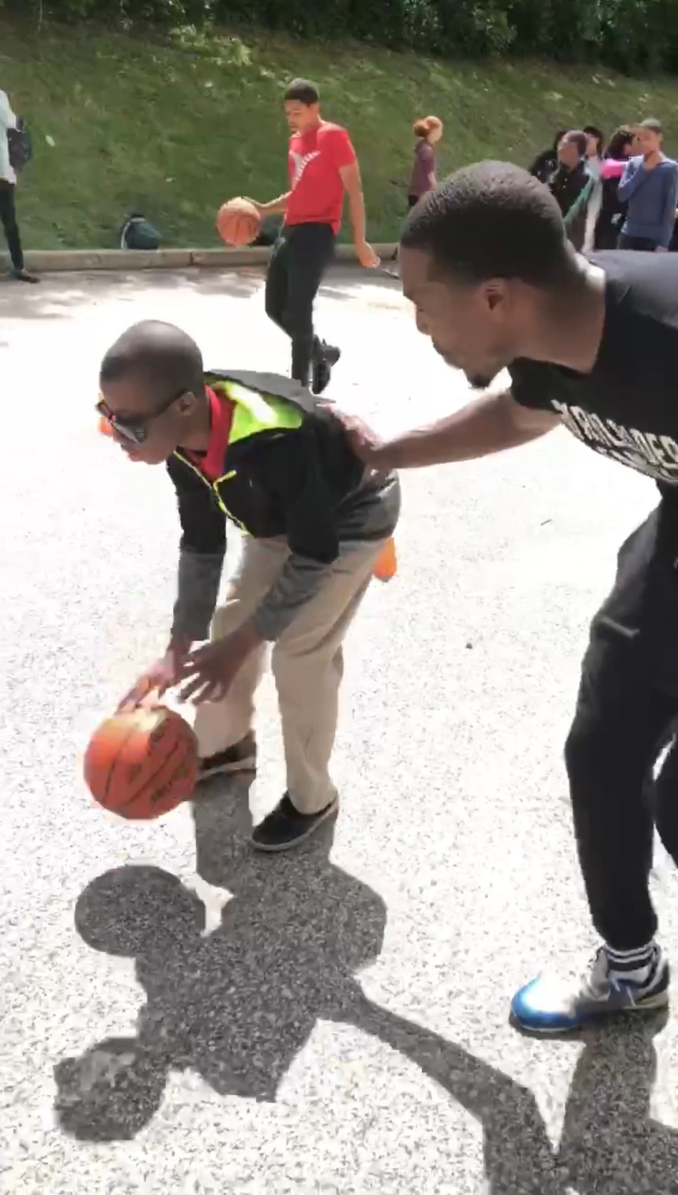 Child with special needs learning to dribble with Coach Tasheed