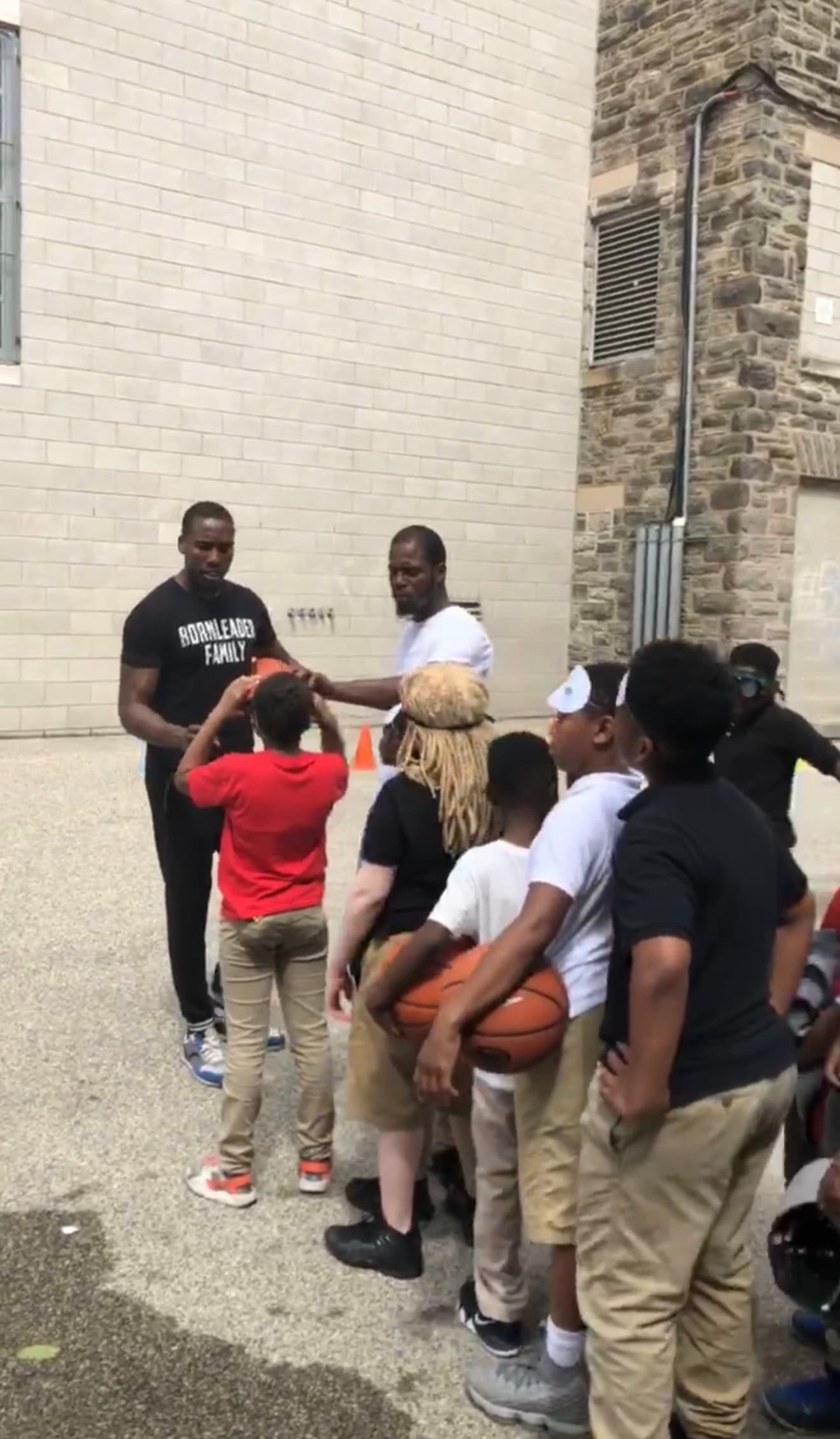 Tasheed Carr with a group of children at a Born Leader Family special needs basketball event